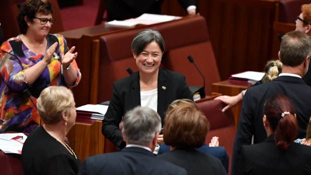 Senators celebrate the result with Labor's Penny Wong.