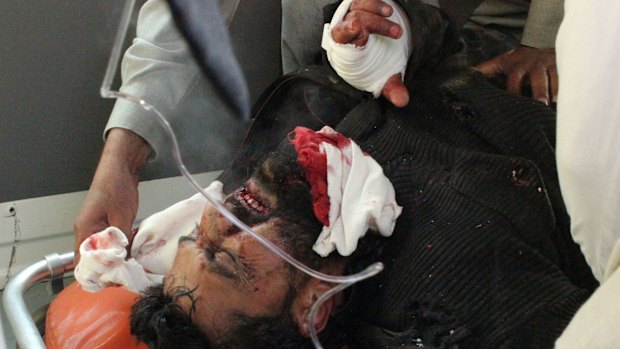 Pakistani volunteers rush an injured man to hospital after the attack.