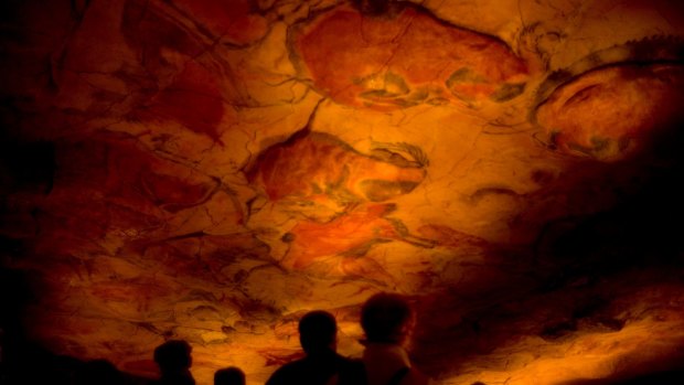 Tourists inside the cave's replica in Spain.