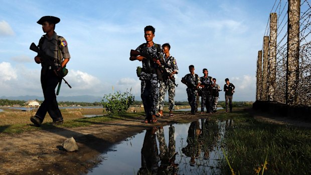 Myanmar police officers patrol  the border between Myanmar and Bangladesh in October. An attack on police at the border in October sparked the latest surge of violence.