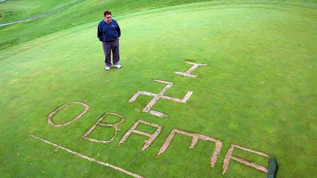 Lakeville Country Club owner Gary Mosca looks down at a message carved into the 18th green on October 13, 2009, in Lakeville, Massachusetts. 