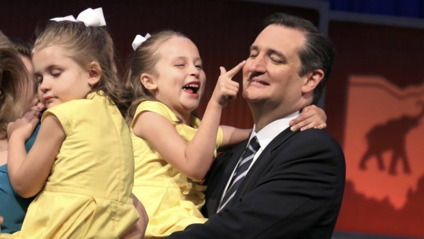 Candidate Ted Cruz hugs his daughters onstage at the end of the debate. 