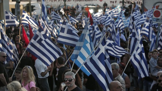 Supporters of the extreme far-right Golden Dawn party wave Greek flags in Athens last week.
