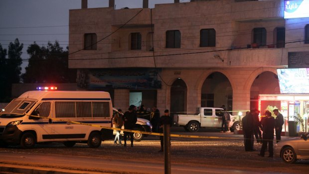 Jordanian police inspect the scene in al-Qatranah where attackers first opened fire on arriving policemen killing two and escaping to al-Karak where they continued to the Crusader Castle.