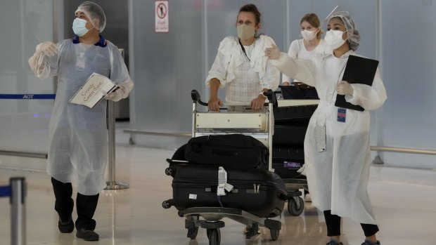 Hotel workers pick up arriving tourists at Suvarnabhumi International Airport in Bangkok on Monday, November 1 as borders reopen.