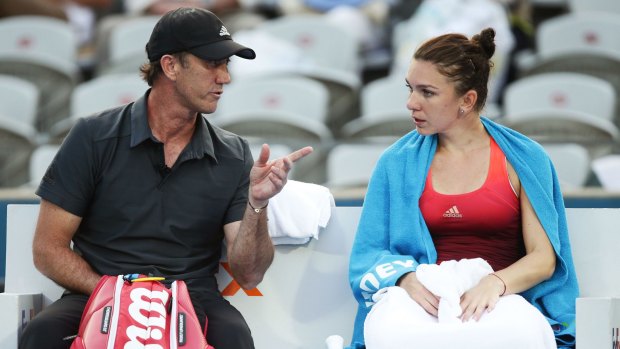 Simona Halep talks to her coach Darren Cahill between games in Sydney.