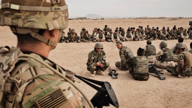 A US Army soldier oversees training for members of the 215th Corps of the Afghan National Army at Camp Bastion in Helmand Province, Afghanistan, in March.