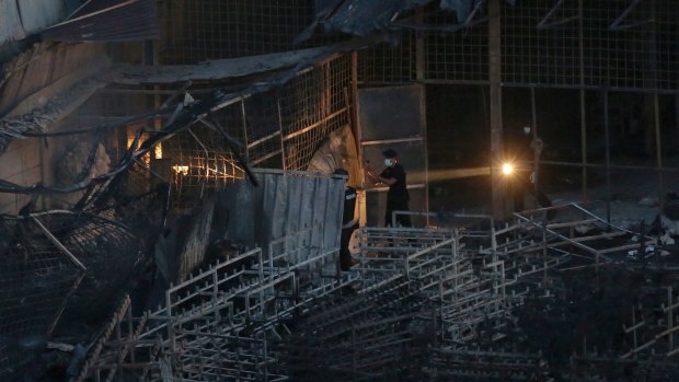 Police officers search for bodies on the site of the fireworks factory explosion in Tangerang, on the outskirts of Jakarta, Indonesia.