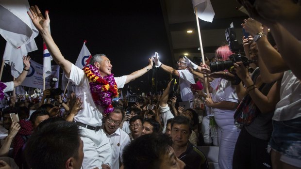 Lee Hsien Loong, Singapore's prime minister and leader of the People's Action Party (PAP), celebrates his party's win with supporters in Singapore on Saturday.