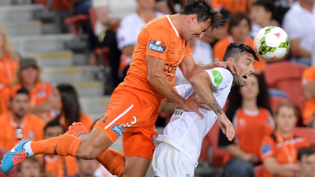 Shane Stefanutto of the Roar and Jason Hoffman of Melbourne City vie for the ball.