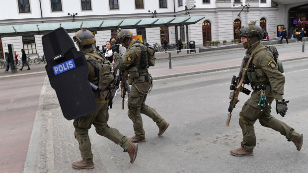 Heavily armed police arrive in central Stockholm.