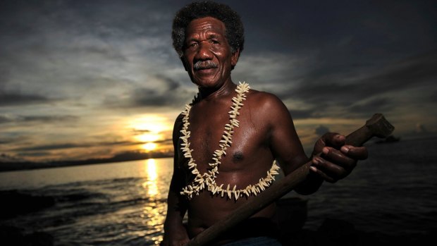 A dolphin catcher and exporter wearing a necklace made from the teeth of 22 dolphins . 