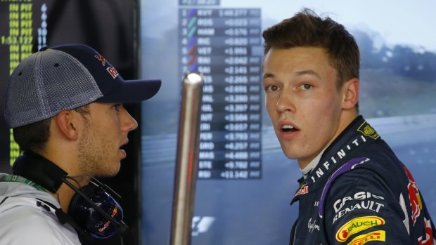 Red Bull driver Daniil Kvyat talks with a mechanic during the second practice session.