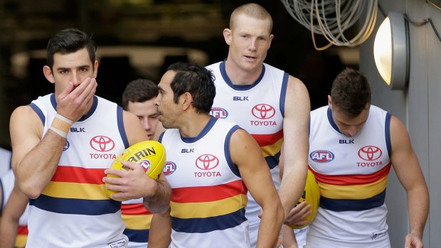 Taylor Walker leads out the Crows on the first anniversary of the death of their coach Phil Walsh, in 2016.