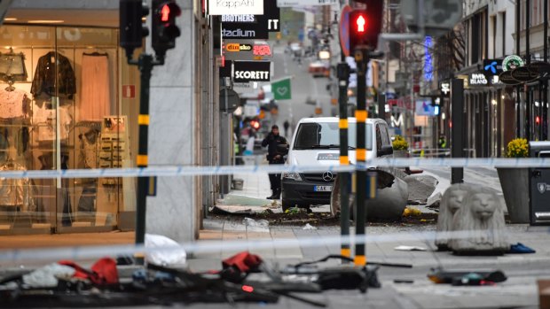 A police officer stands at the cordoned off area following a truck attack on the Drottninggatan in central Stockholm, Sweden.