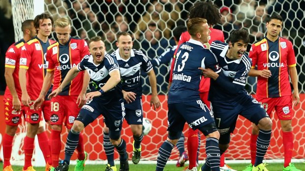 Gui Finkler of Melbourne Victory celebrates with teammates after scoring against Adelaide on Tuesday night.