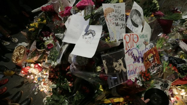 Floral tributes are placed near a mural of British singer David Bowie in Brixton, south London.