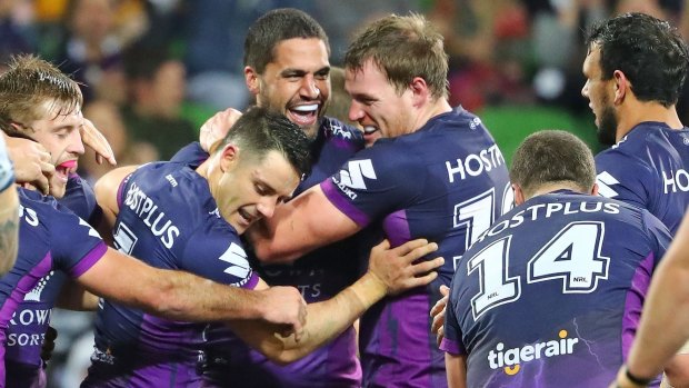 Jesse Bromwich of the Storm is congratulated by Cooper Cronk and his teammates after scoring against the Cowboys in the qualifying final.