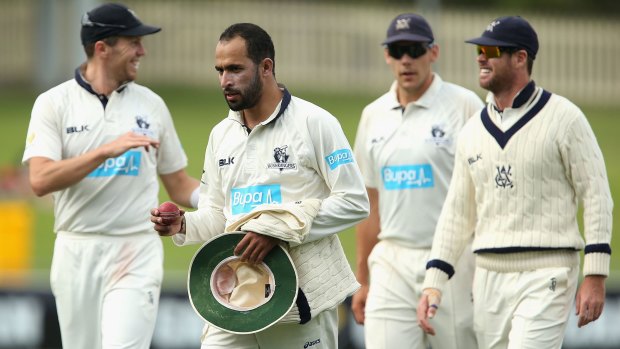 Fawad Ahmed of Victoria walks off holding the ball after taking eight wickets against Western Australia.