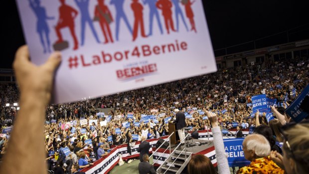 A supporter holds a sign as Senator Bernie Sanders speaks in Carson, California.
