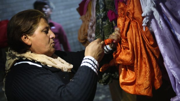 A Yazidi woman ties a knot in a scarf last week, as a way to make a wish in the temple of Lalis, in Lalish, Nineveh Province, Iraq.