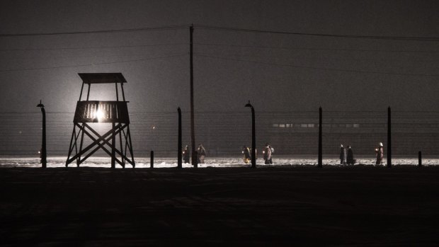 Auschwitz survivors and families visit the Birkenau Memorial carrying candles on January 27, 2015.