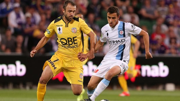 Wade Dekker of Melbourne City controls the ball as Gyorgy Sandor of the Glory approaches.