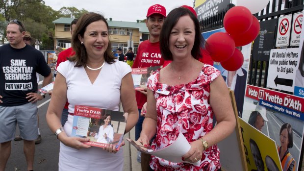 Yvette D'Ath and Annastacia Palaszczuk hand out how to vote cards at the 2015 election. 