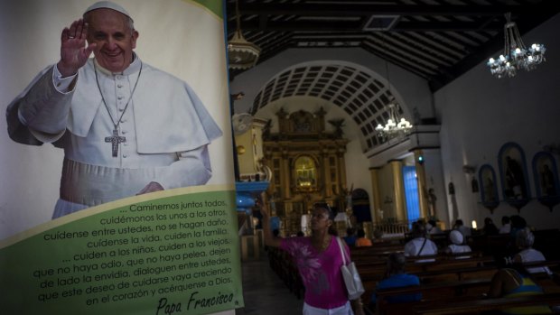 A woman prays next to a photo of Pope Francis in the town of Regla, across the bay from Havana, Cuba, earlier this month. 