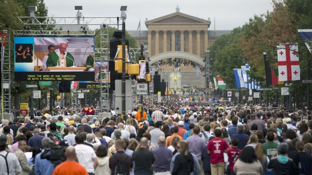 Pope Francis is seen on a huge screen on Benjamin Franklin Parkway in Philadelphia on Sunday.