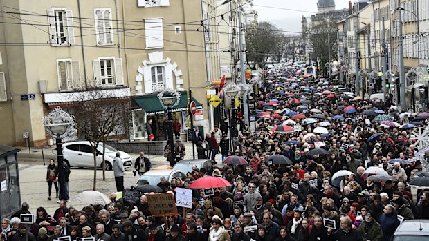 People hold signs reading "Je Suis Charlie" (I am Charlie) march in Limoges on Saturday.