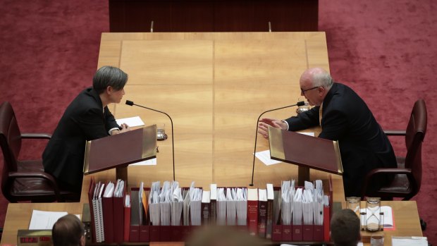 Leader of the Opposition in the Senate, Penny Wong, and Attorney-General George Brandis in discussion in the Senate on Thursday.