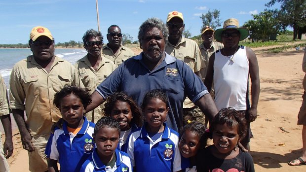 Djambawa Marawili, artist and elder, with local Indigenous rangers and children from the Yilpara Homelands School,Arnhemland. 