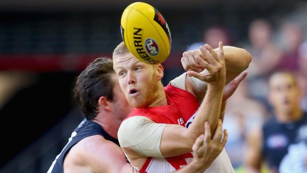 In the nick of time: Dan Hannebery handballs while being tackled.