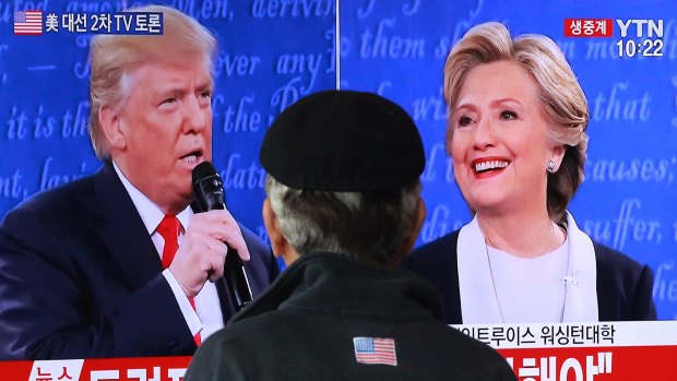 A man watches the debate at Seoul railway station in South Korea.