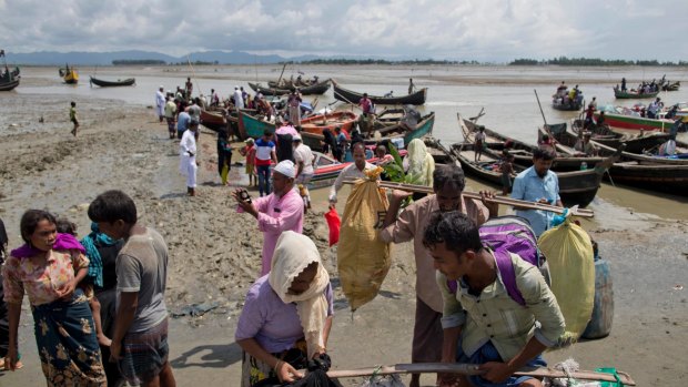 Newly arrived Rohingya Muslims from Myanmar disembark from boats as they continue their journey to camps in Bangladesh on Monday.