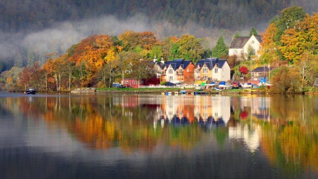 The ptcture book perfect town of Kenmore reflected on Loch Tay.