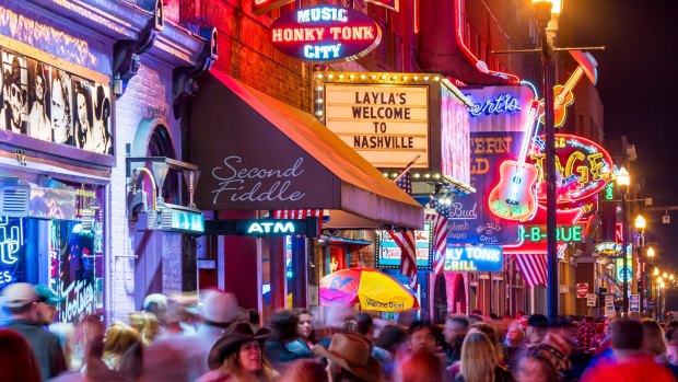 Lower Broadway, where country music rolls out of the neon-dipped honky tonks.