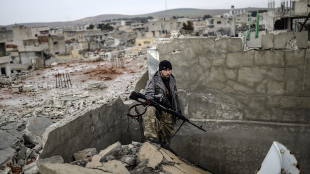 Musa stands in the rubble of Kobane on January 30. 