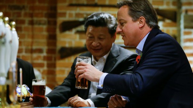 Then British PM David Cameron, right, drinks a pint with Chinese President Xi Jinping at The Plough pub in Cadsden, Buckinghamshire.