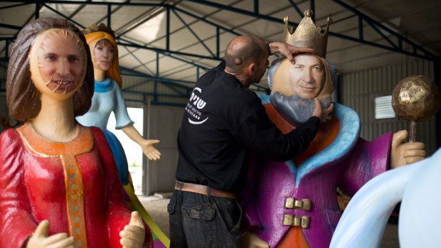 An artist works on an effigy of Israeli Prime Minister Benjamin Netanyahu, alongside effigies of MP Zahava Gal-On, head of the leftist Meretz party, and Economy Minister and head of the far-right Jewish Home party, Naftali Bennett, left.