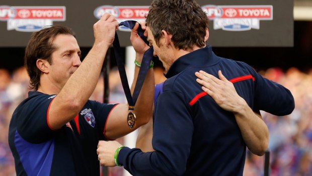 Beveridge presents Murphy with his medal.