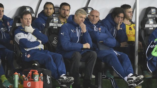 Arsenal manager Arsene Wenger (centre) shows his disappointment at the end of the match against Swansea City on Sunday.