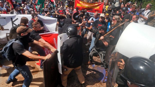White nationalist demonstrators clash with counter demonstrators at the entrance to Lee Park in Charlottesville, Virginia, on August 12.