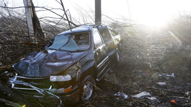 A vehicle sits among debris near the home of Antonio Yzaguirre, 70, and his wife, Ann Yzaguirre, 69, near Linden, Tennessee.