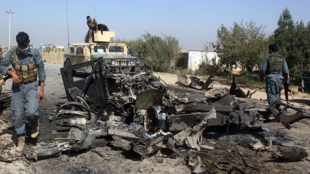 Afghan security forces inspect the site of a US air strike in Kunduz city, north of Kabul, Afghanistan, last month.