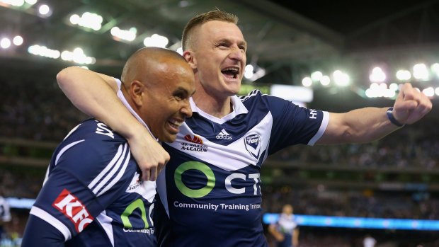 Archie Thompson of the Victory is congratulated by teammate Besart Berisha after scoring Melbourne Victory's third goal.