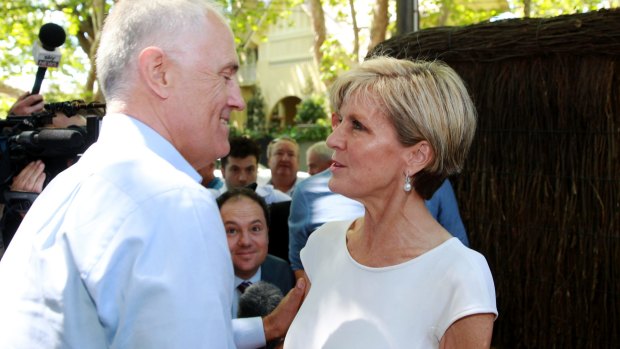 All for the cameras: Malcolm Turnbull greets Julie Bishop outside a fundraising event on Sunday.