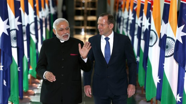 Indian Prime Minister Narendra Modi talks to Prime Minister Tony Abbott during his visit to Australia in November 2014.