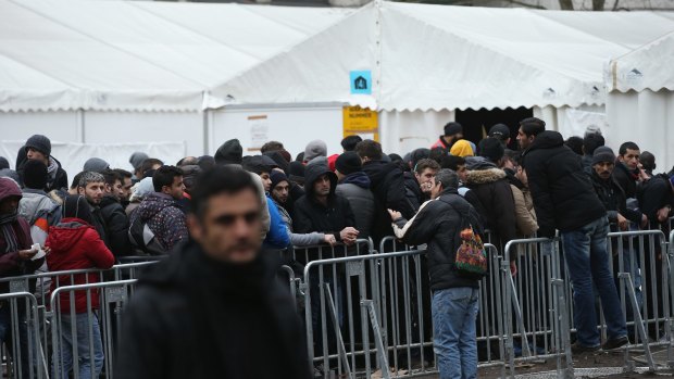 Asylum seekers wait outside a Berlin social security office to receive their benefits in January. More than a million migrants have arrived in Germany since the start of the migrant crisis.